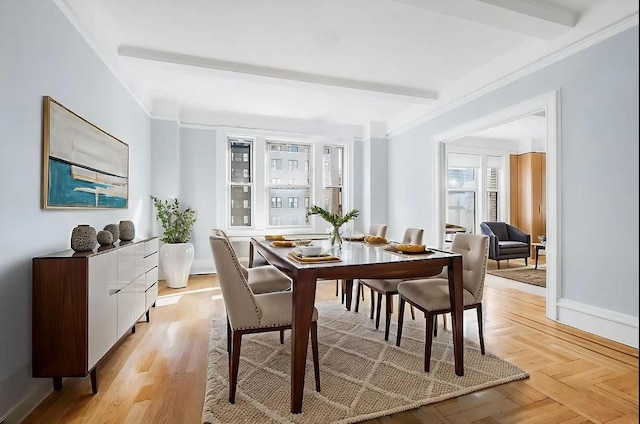 dining room featuring ornamental molding, beam ceiling, and light parquet floors