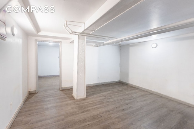 basement with hardwood / wood-style floors