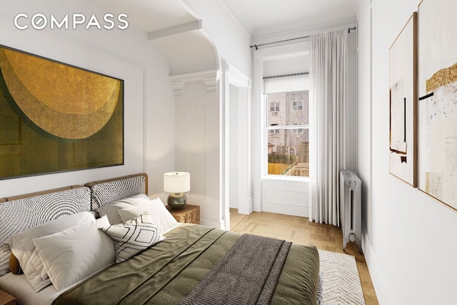 bedroom featuring radiator heating unit, crown molding, and light parquet floors