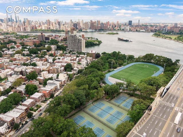 birds eye view of property with a water view and a city view