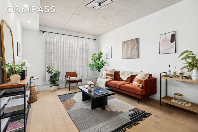 living room featuring visible vents and light wood-style flooring