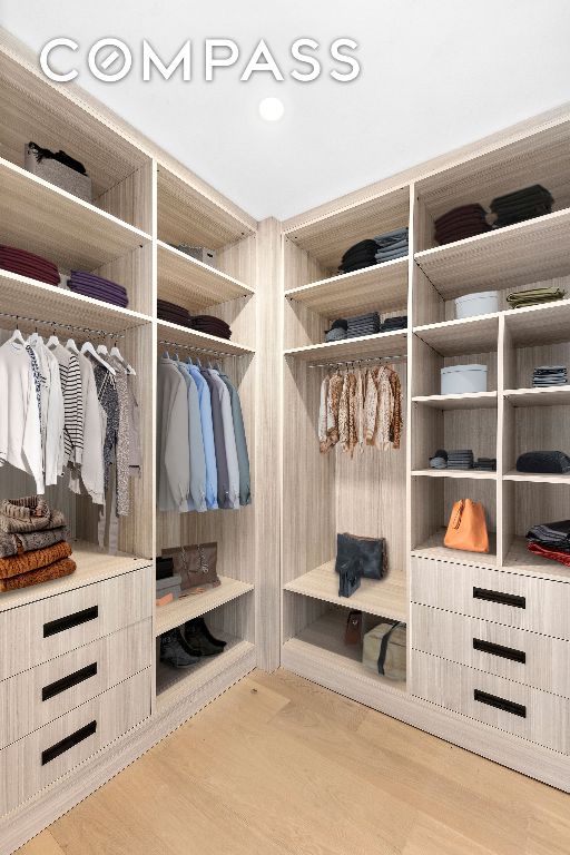 walk in closet with light wood-type flooring