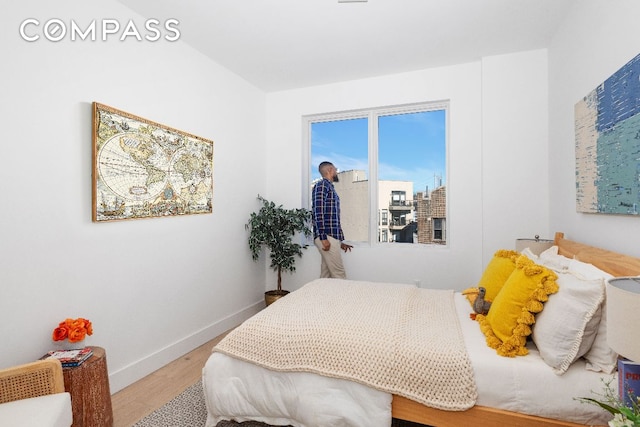 bedroom with wood finished floors and baseboards