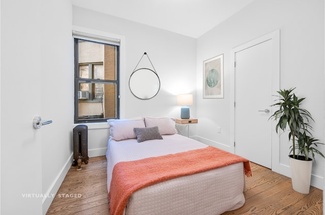 41 Clarkson Ave Unit 2E, New York City, NY 11226 - bedroom featuring radiator heating unit, wood finished floors, and baseboards
