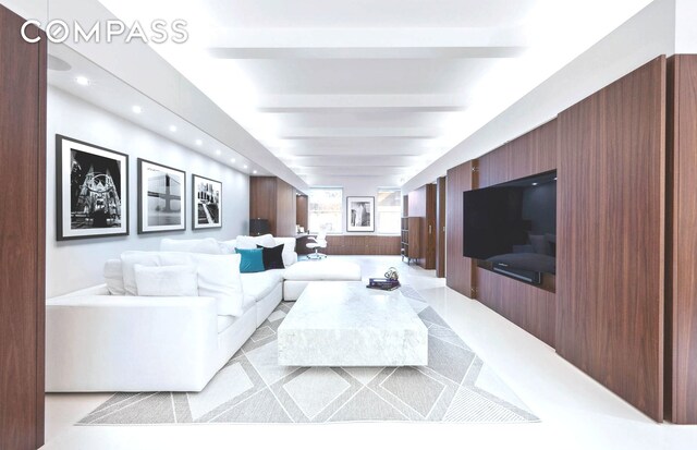 living room featuring beam ceiling and recessed lighting