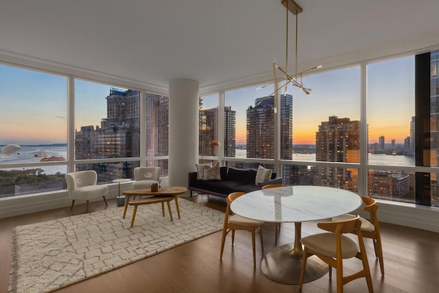 sunroom / solarium with a view of city and a water view