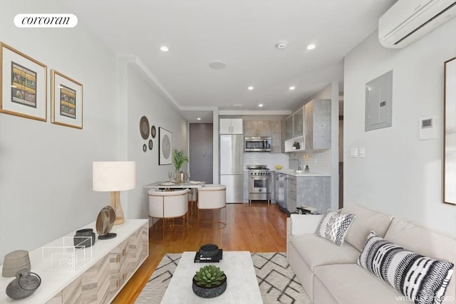 living room featuring light wood finished floors, recessed lighting, visible vents, a wall mounted AC, and electric panel