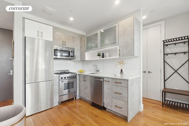 kitchen with visible vents, light countertops, appliances with stainless steel finishes, open shelves, and glass insert cabinets