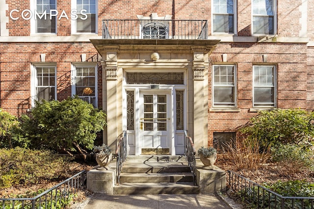 doorway to property featuring brick siding