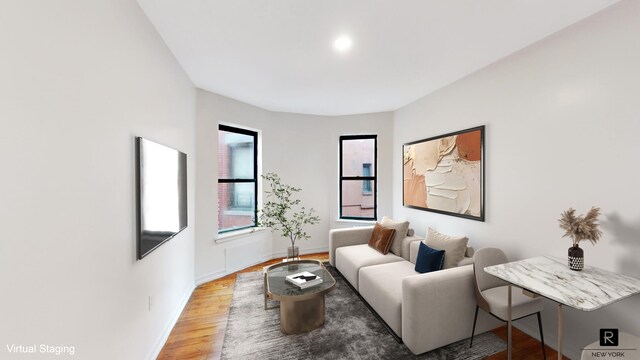 living room with baseboards and wood finished floors