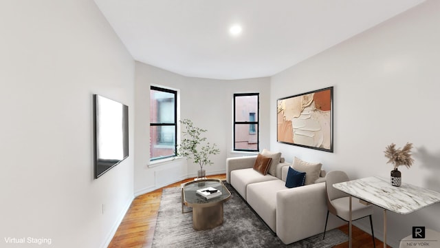 living area featuring baseboards and wood finished floors