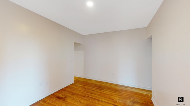 unfurnished room featuring light wood-style floors, baseboards, and recessed lighting