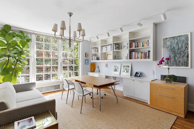 134 E 62nd St, New York City, NY 10065 - office area with rail lighting, a chandelier, and light wood-style floors