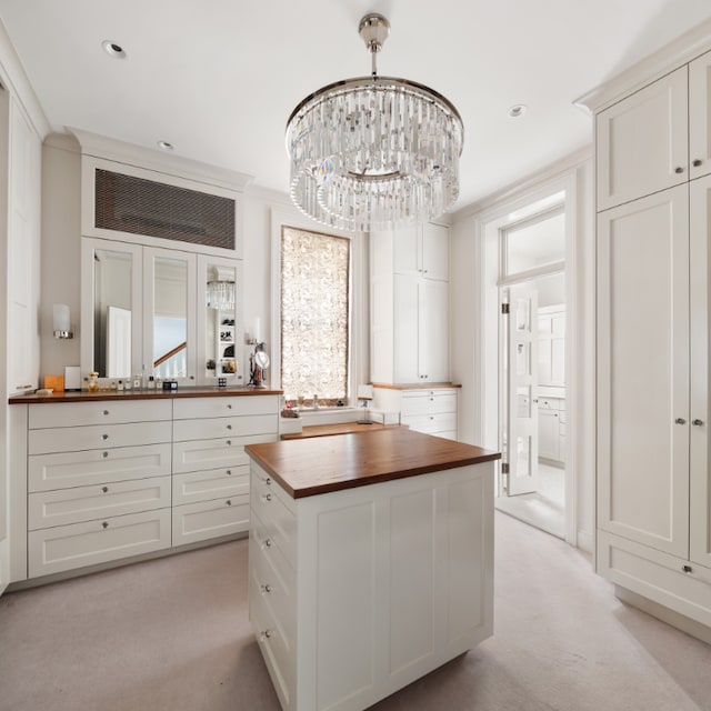 interior space featuring light colored carpet and an inviting chandelier