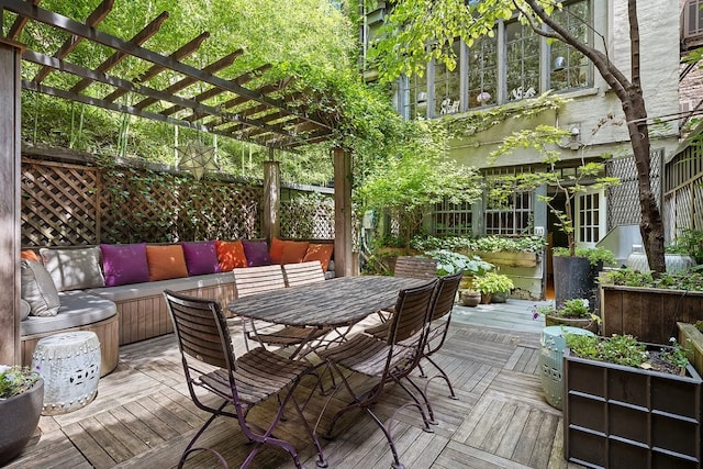 wooden terrace featuring an outdoor hangout area and a pergola