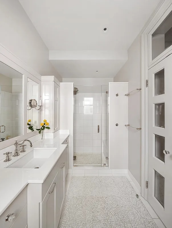 134 E 62nd St, New York City, NY 10065 - bathroom featuring a shower stall, tile patterned flooring, and vanity