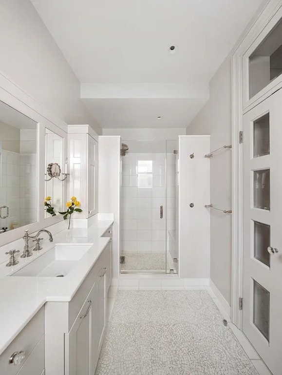 bathroom with vanity, tile patterned flooring, and a shower with door