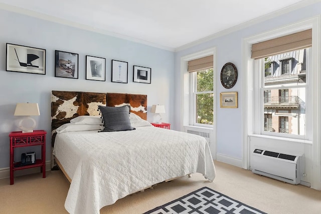 bedroom with ornamental molding, an AC wall unit, and light colored carpet