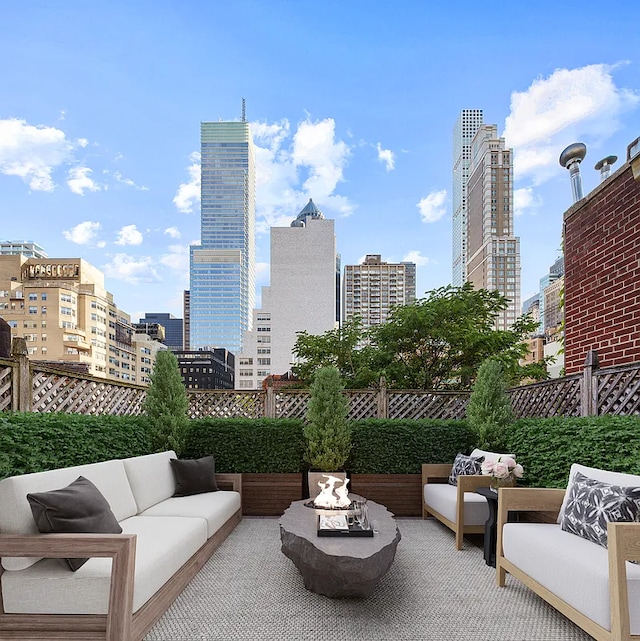 134 E 62nd St, New York City, NY 10065 - view of patio / terrace featuring an outdoor living space with a fire pit and a view of skyline