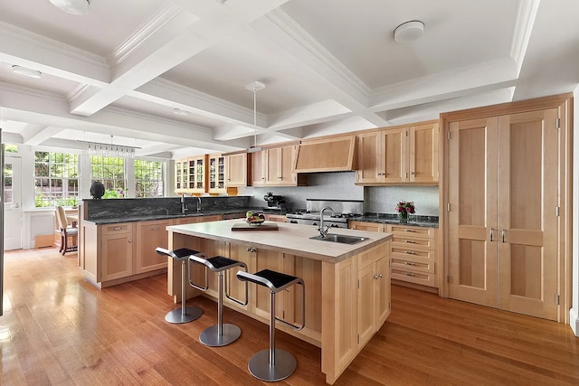 134 E 62nd St, New York City, NY 10065 - kitchen featuring custom range hood, light wood finished floors, coffered ceiling, light brown cabinets, and a peninsula
