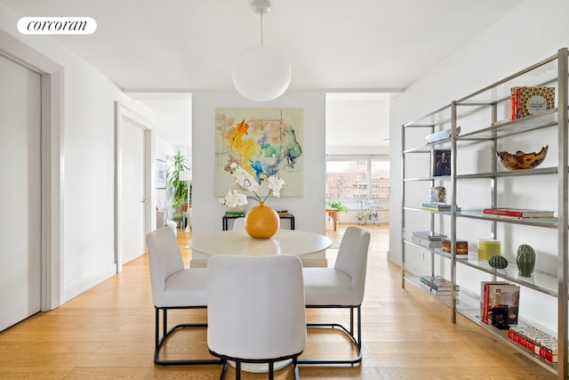 dining room with light wood-type flooring and visible vents