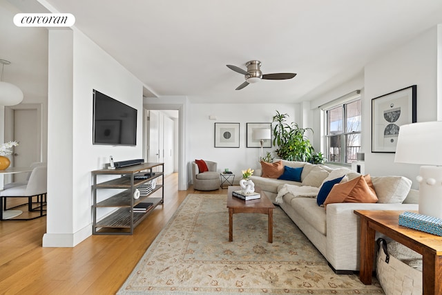 living room featuring light wood-type flooring and ceiling fan