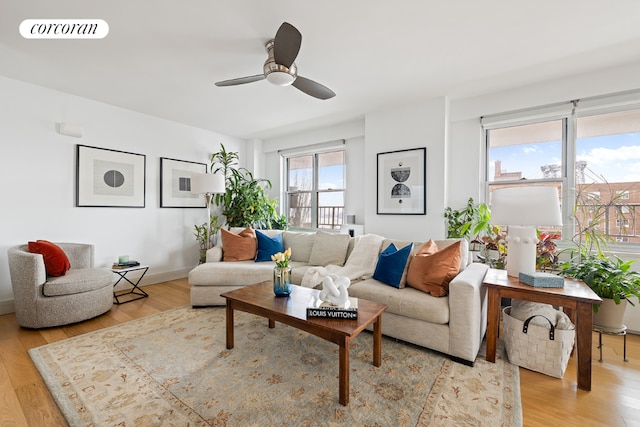 living room featuring hardwood / wood-style flooring and ceiling fan