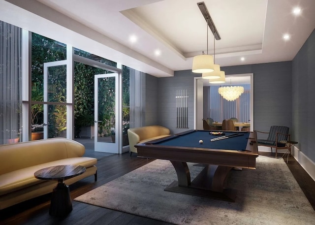 recreation room with a tray ceiling, pool table, and dark hardwood / wood-style floors