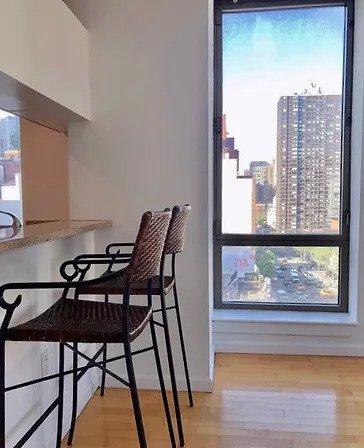 dining space with baseboards and light wood-style flooring