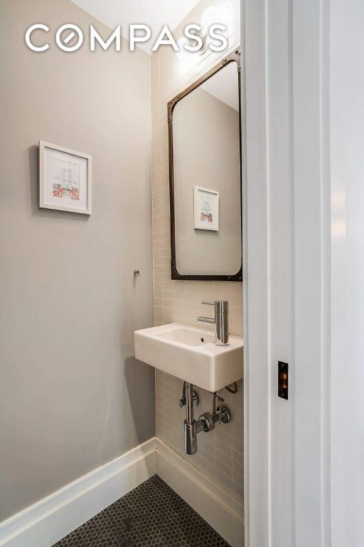 bathroom featuring tile patterned flooring and baseboards