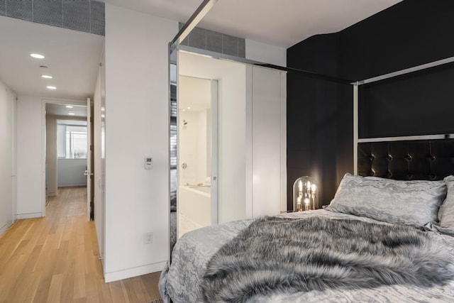 bedroom featuring light wood-style flooring, recessed lighting, and baseboards