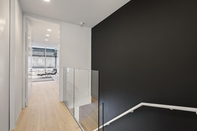 hallway featuring light wood-style flooring and recessed lighting