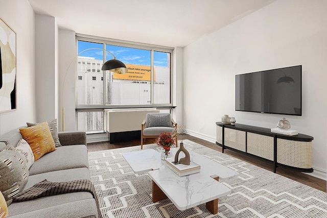 401 E 60th St Unit 5J, New York City, NY 10065 - living room featuring wood finished floors and baseboards