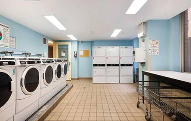401 E 60th St Unit 5J, New York City, NY 10065 - shared laundry featuring washing machine and clothes dryer and stacked washer / dryer