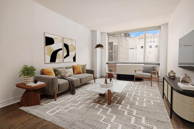 living room with baseboards and wood finished floors