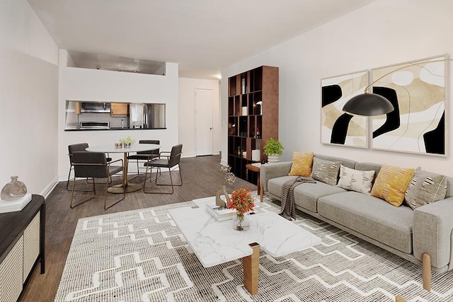 living room featuring baseboards and wood finished floors