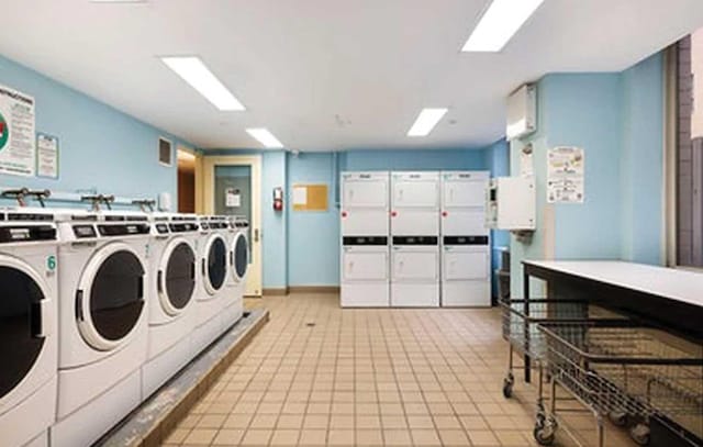 401 E 60th St Unit 5J, New York City, NY 10065 - shared laundry featuring washing machine and clothes dryer and stacked washer / dryer