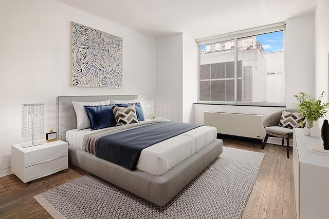 401 E 60th St Unit 5J, New York City, NY 10065 - bedroom with radiator heating unit and wood finished floors