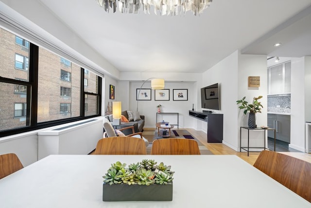 dining room featuring light wood-type flooring and baseboards