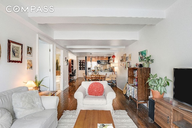 living room with dark wood-type flooring and beamed ceiling