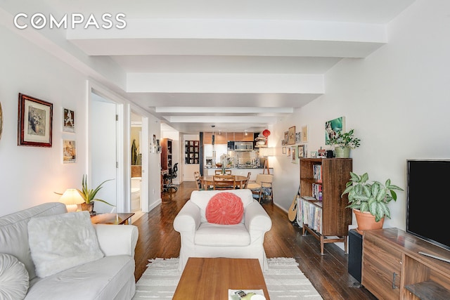 living area with dark wood-type flooring and beam ceiling