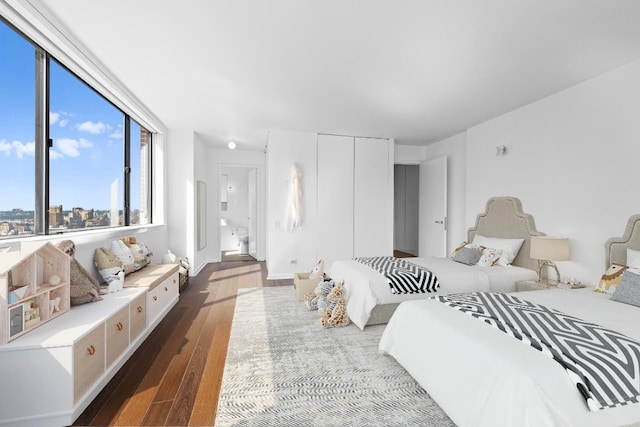 bedroom featuring dark hardwood / wood-style floors and a closet