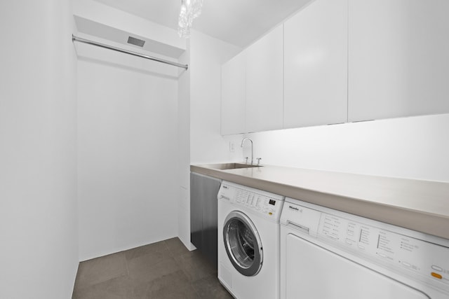 laundry area with cabinets, sink, and independent washer and dryer