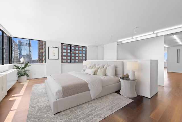 bedroom with hardwood / wood-style flooring