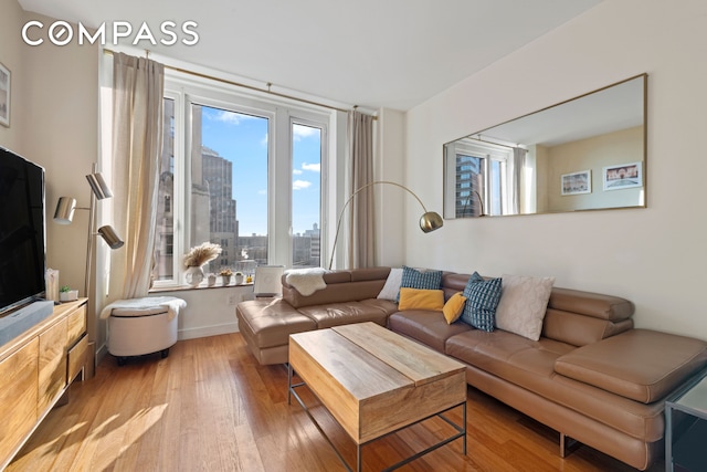 living room with a view of city and wood finished floors