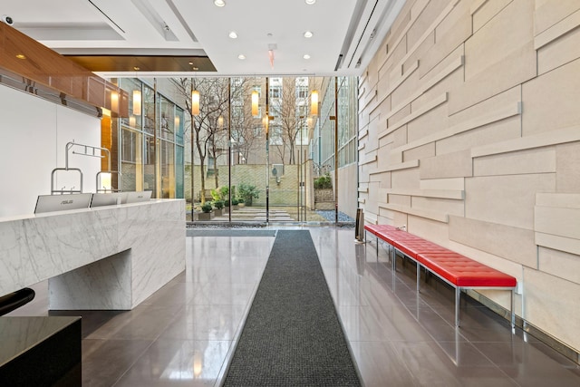 welcome area featuring a wall of windows and recessed lighting