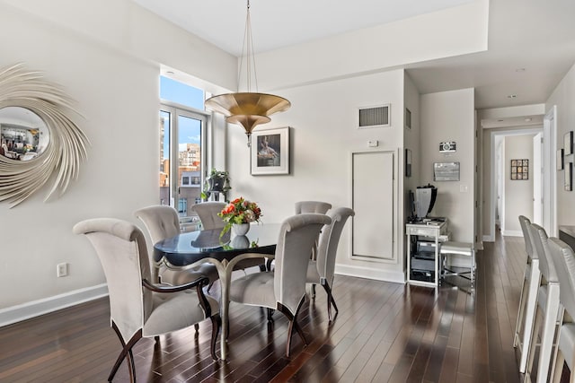 dining space with dark wood-style floors and baseboards