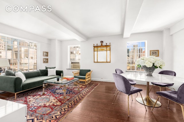 living room featuring dark wood-style floors, cooling unit, beamed ceiling, and baseboards