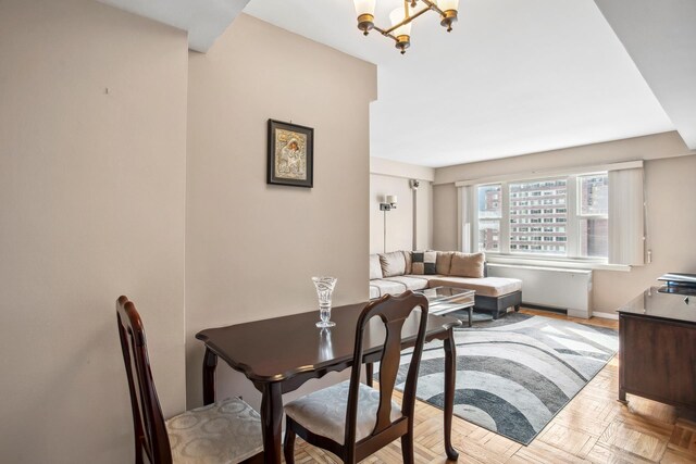 333 E 66th St Unit 11J, New York City, NY 10021 - dining area featuring a chandelier and baseboards