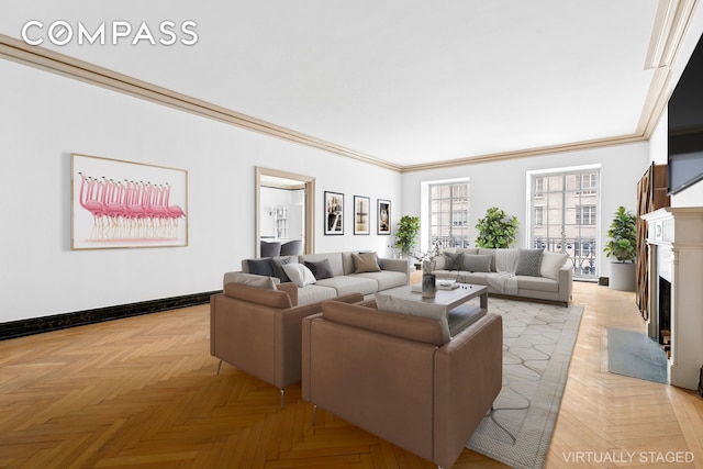 living room with baseboards, a high end fireplace, and crown molding